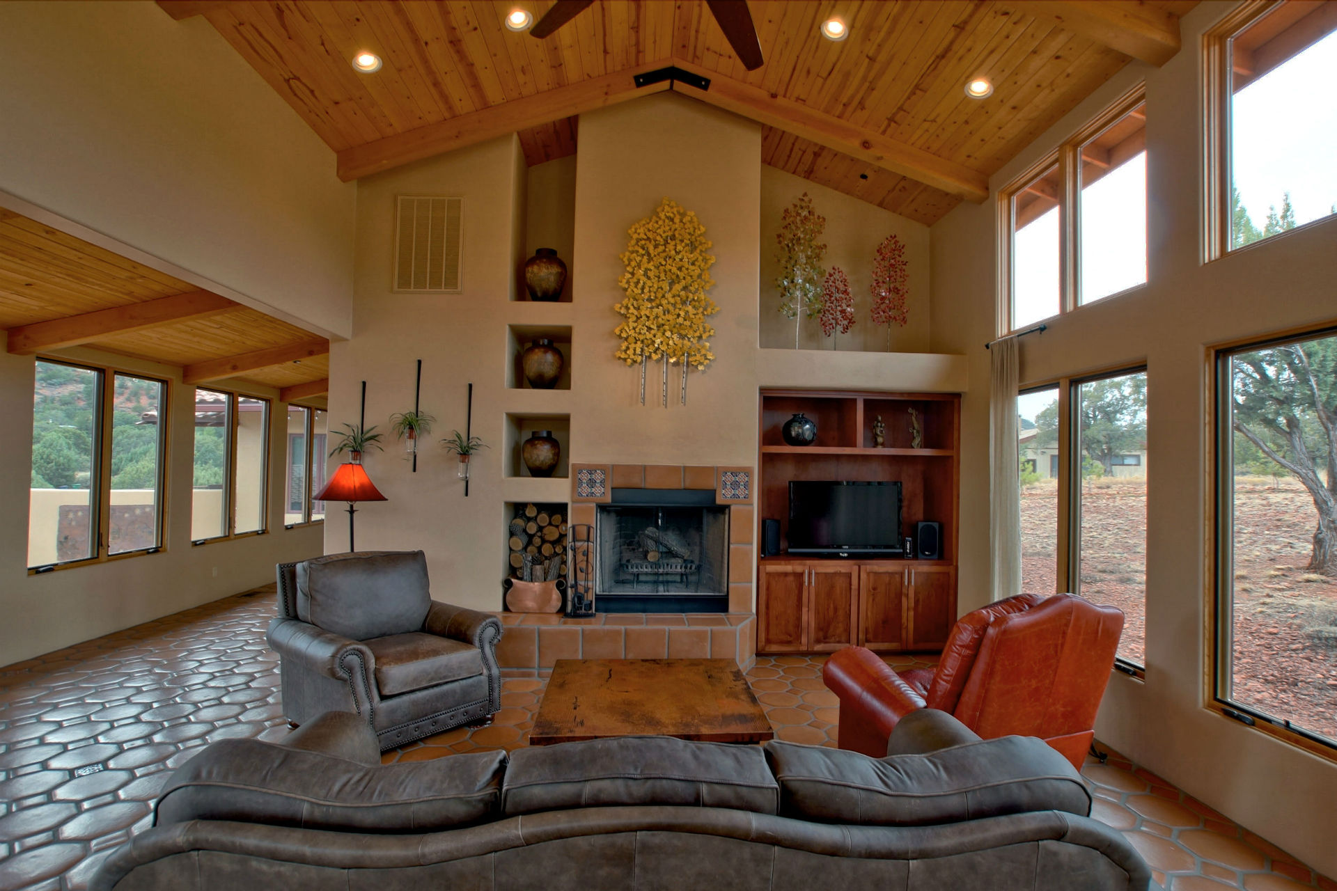 A living room with couches, chairs and a fireplace.