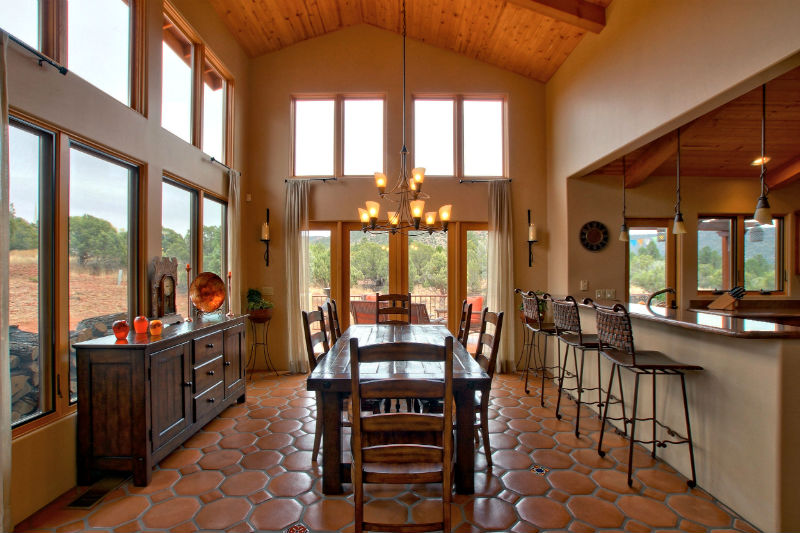 A dining room with a table and chairs in it