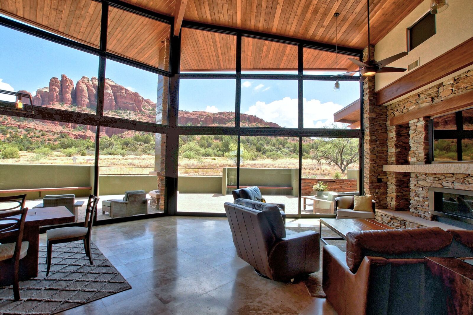 A living room with large windows and a mountain view.