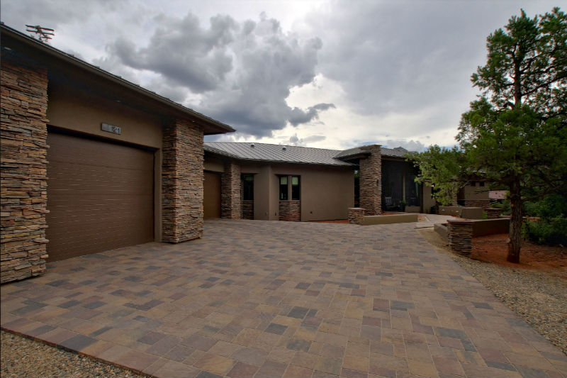 A large brick driveway with a garage door.