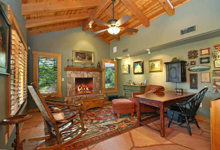 A living room with a fireplace and a table