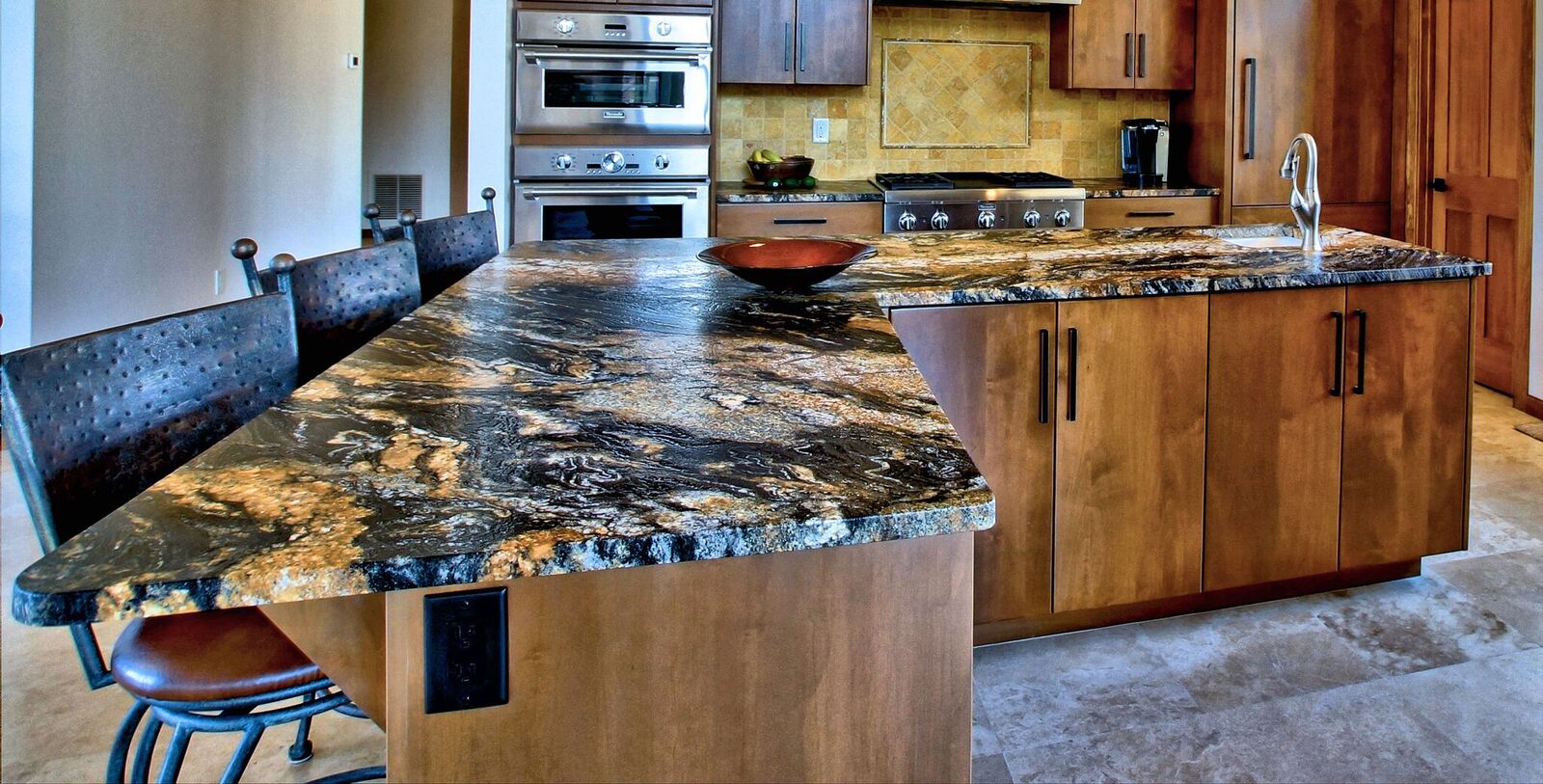 A kitchen with granite counter tops and wooden cabinets.