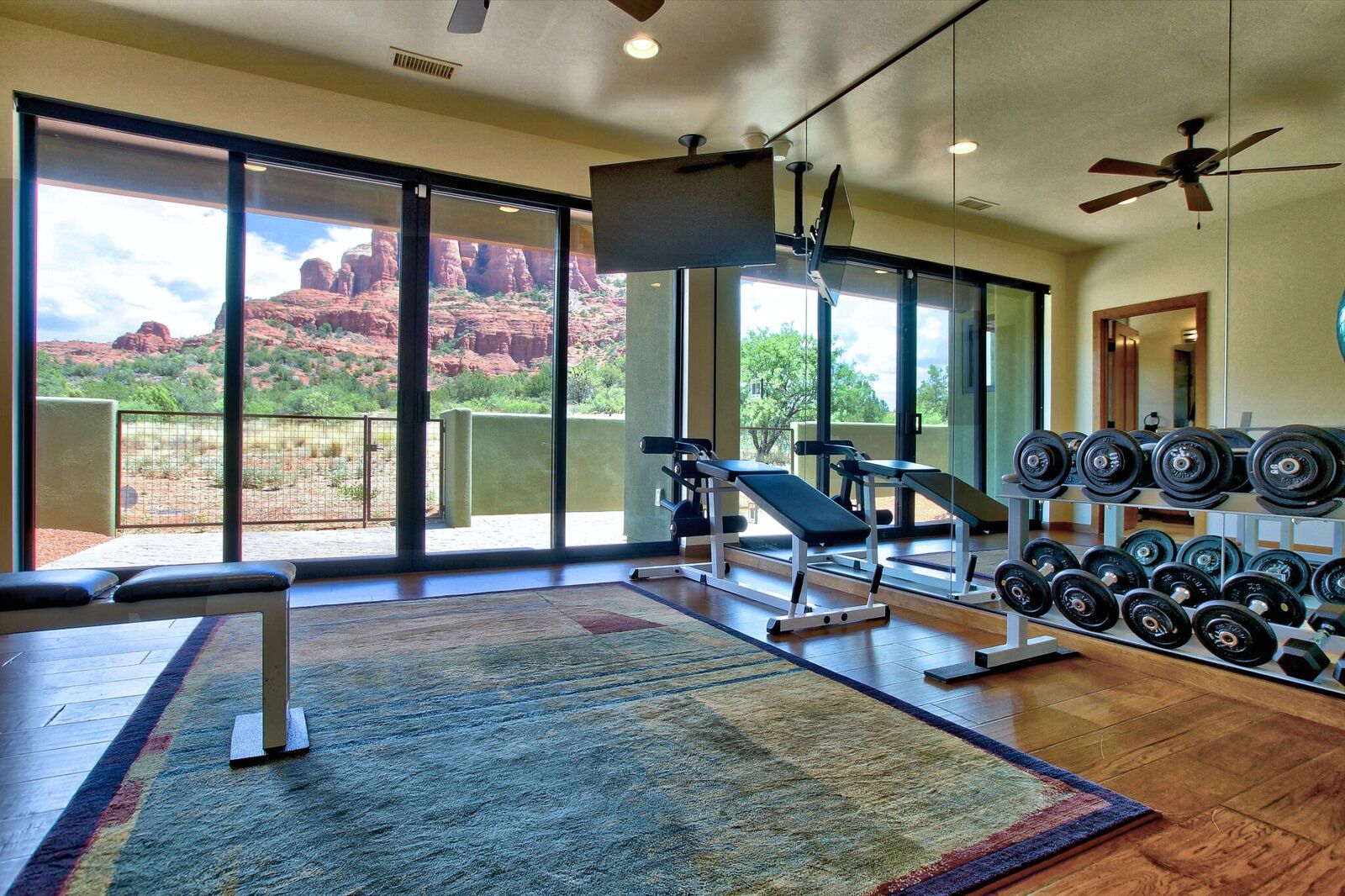 A gym with a view of the mountains and trees.