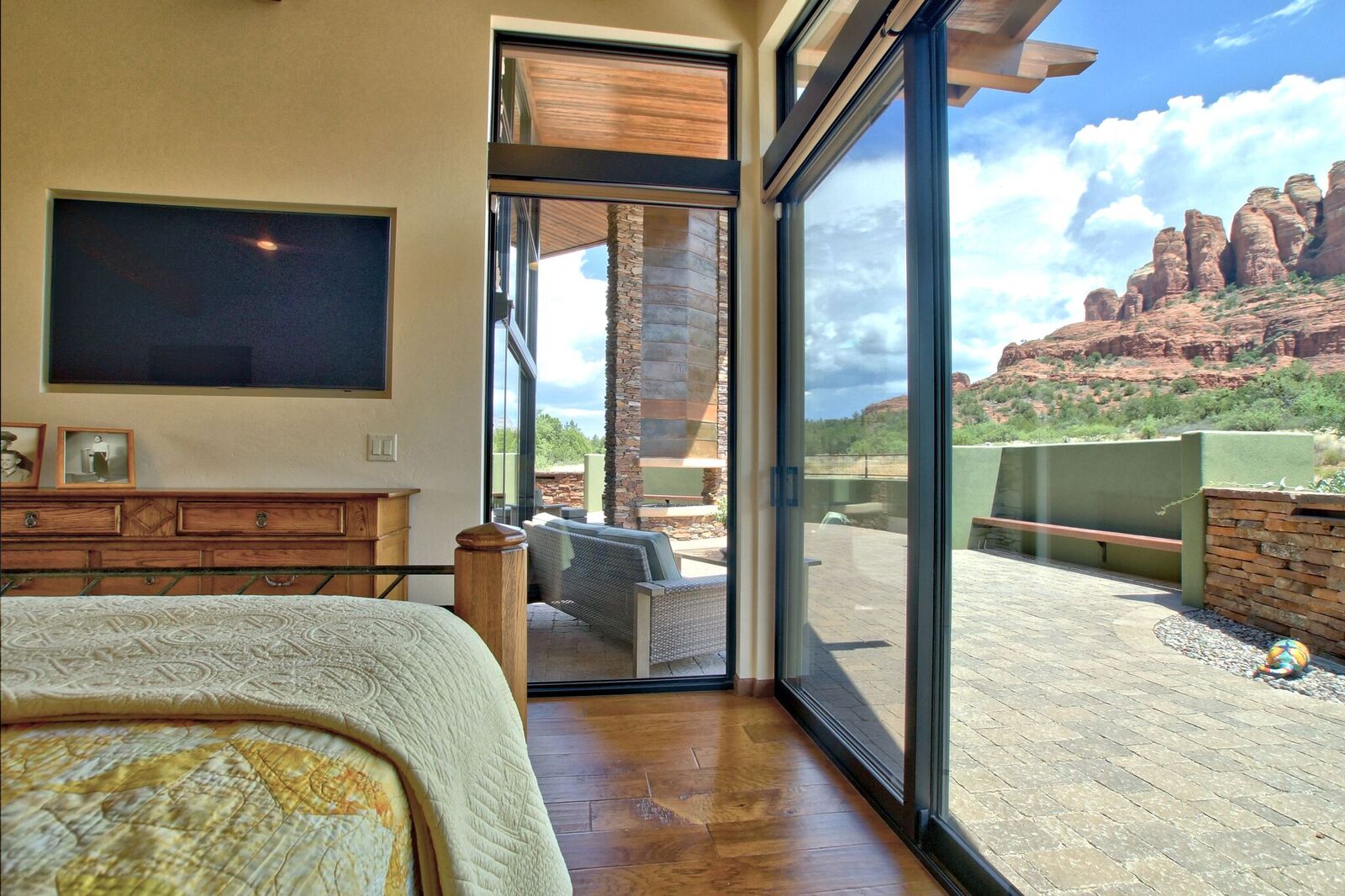 A bedroom with sliding glass doors open to the patio.
