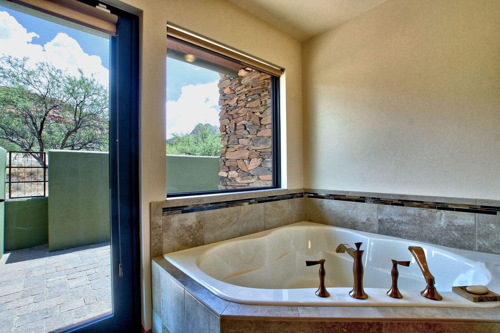 A large bathroom with a tub and window.