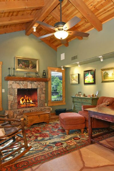 A living room with a fireplace and a table